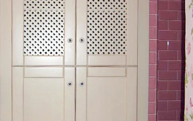 Armario de baño con puertas de rejilla y color crema